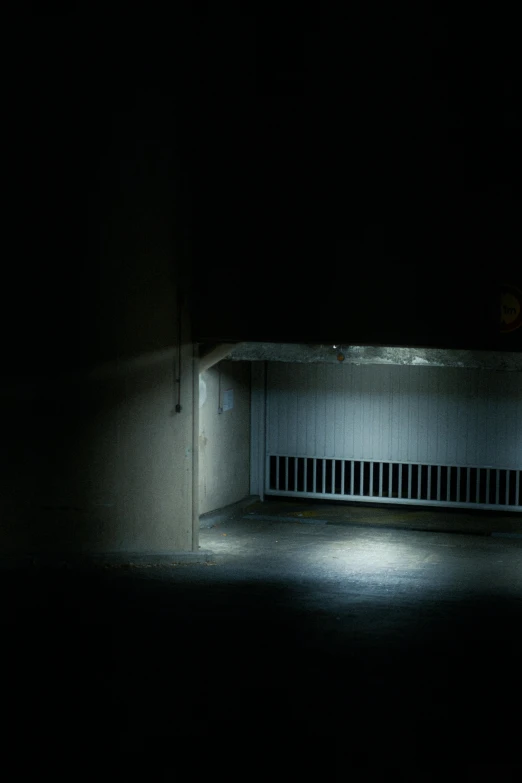 a man riding a skateboard down a dark street, inspired by Elsa Bleda, conceptual art, abandoned car garage, dark. no text, secret entrance, todd hido