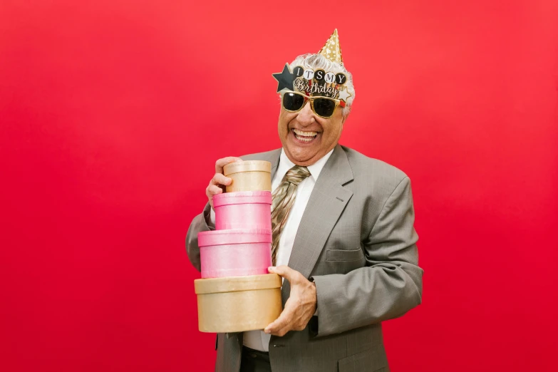 a man wearing a birthday hat holding a stack of presents, pexels contest winner, an oldman, wearing a crown and suit, holding a tin can, laughingstock