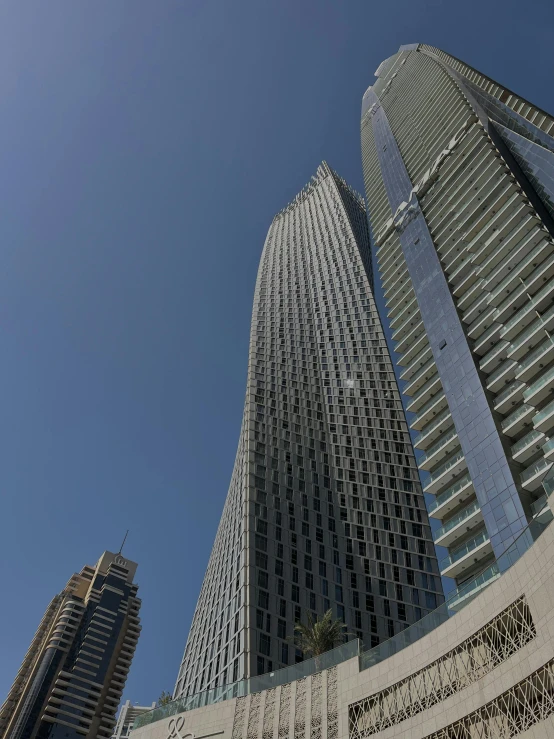 a group of tall buildings sitting next to each other, ameera al taweel, up-close, wide views, splash image