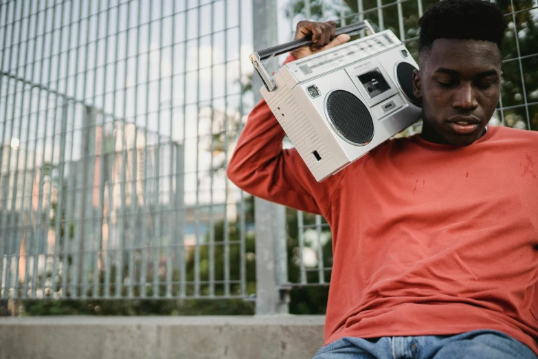 a man sitting on the ground with a boombox on his head, pexels contest winner, happening, black teenage boy, radio box, 15081959 21121991 01012000 4k, thumbnail