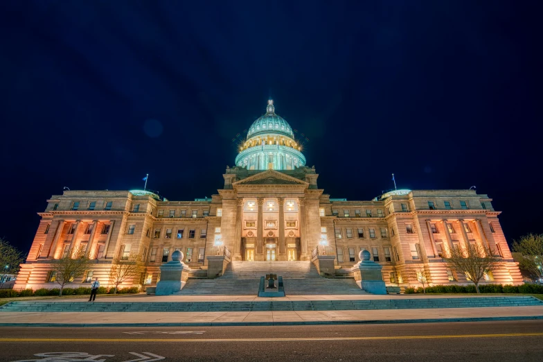 a large building with a dome lit up at night, idaho, split lighting, politics, profile image