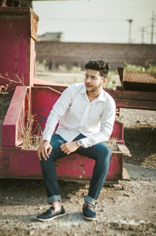 a man sitting on the back of a red truck, inspired by Saurabh Jethani, pexels contest winner, renaissance, white shirt and jeans, zayn malik, profile image, portrait full body