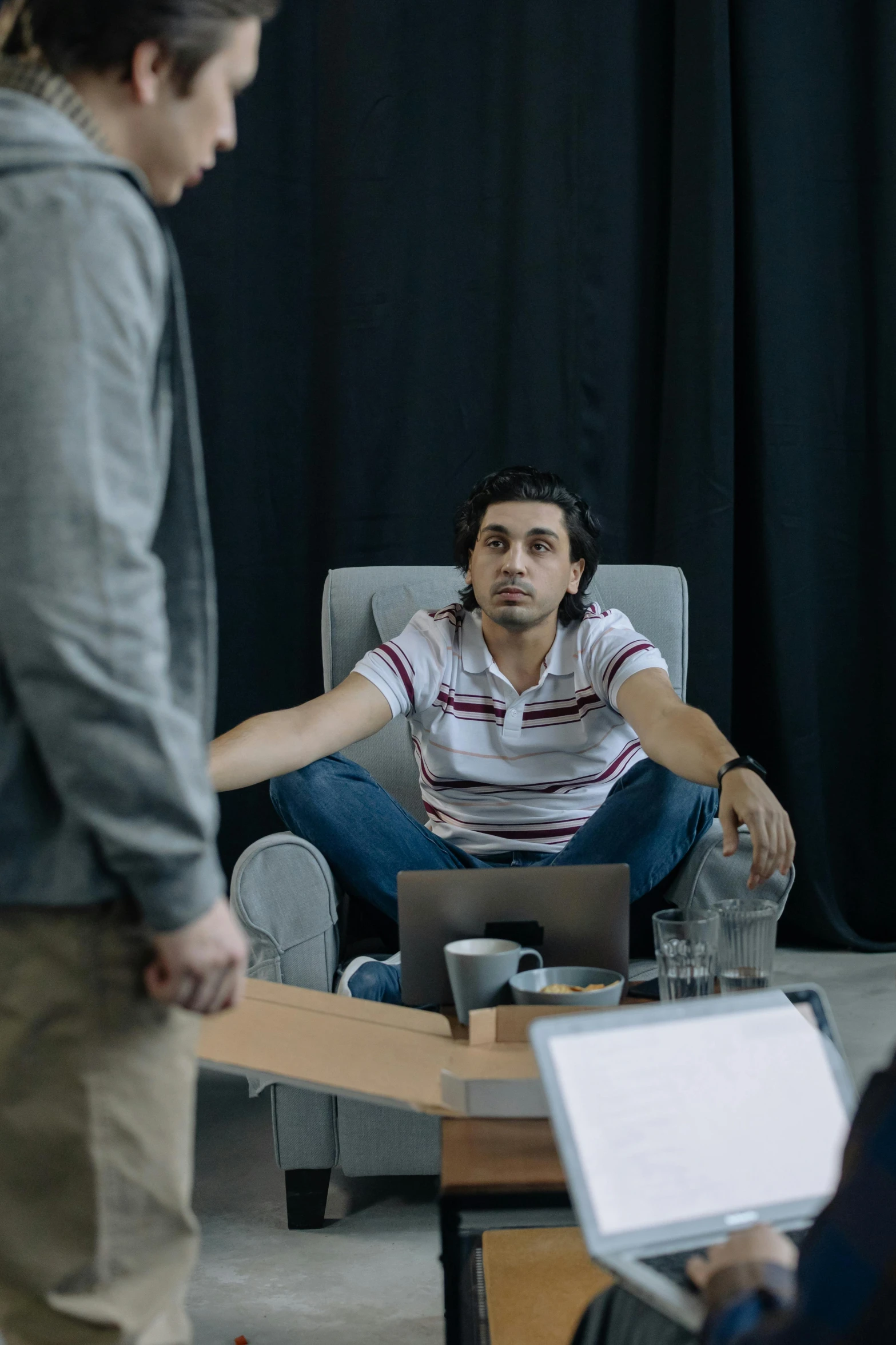 a group of people sitting around a table with laptops, hyperrealism, ( ( theatrical ) ), performance, medium shot of two characters, ash thorp khyzyl saleem