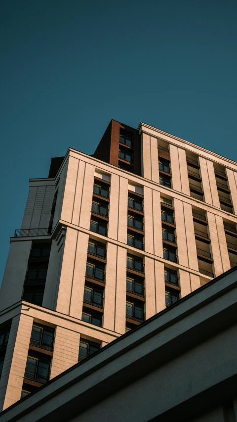 a tall building with a clock on top of it, unsplash, modernism, paul barson, low quality photo, soviet apartment building, thumbnail