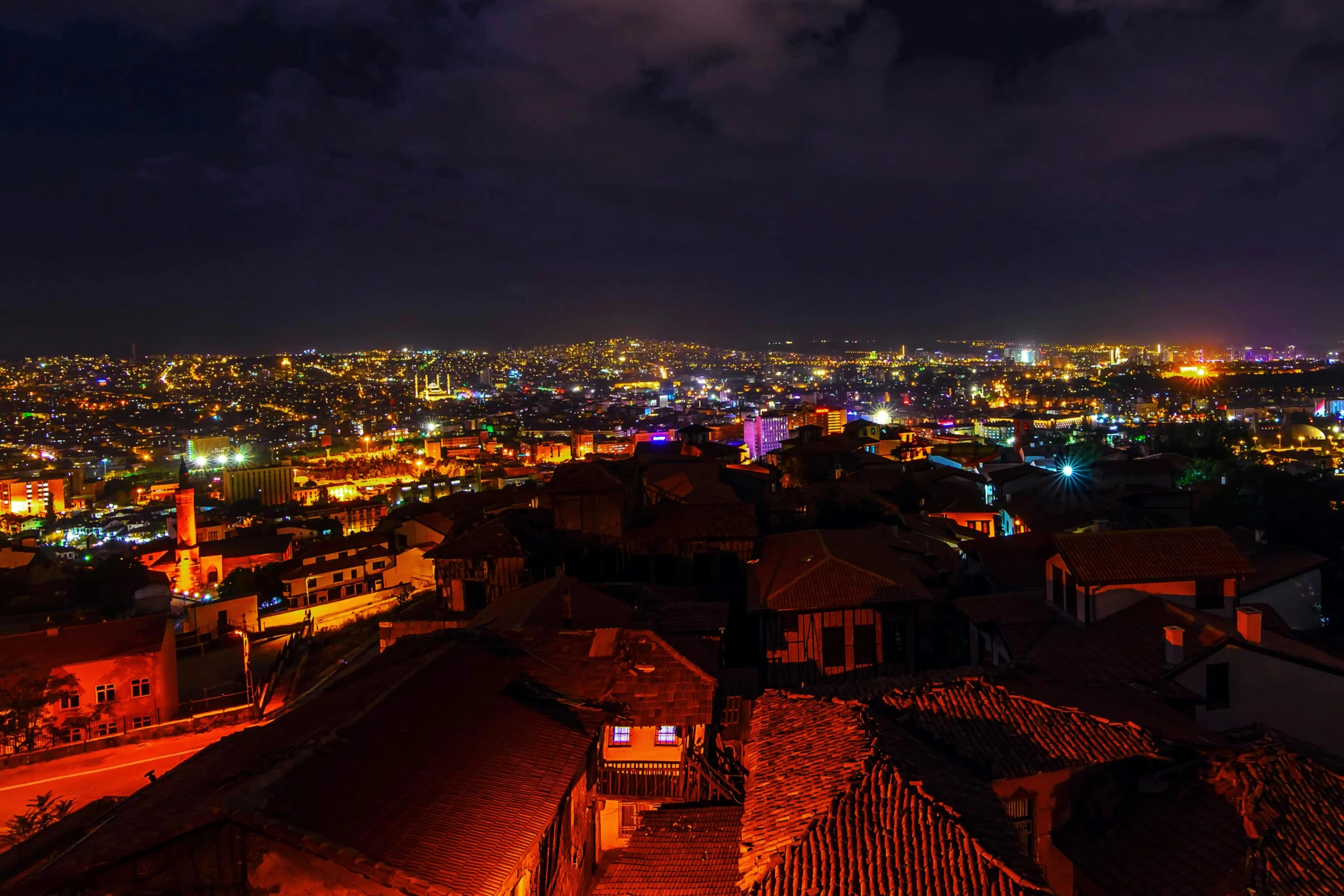 a view of a city at night from the top of a hill, an album cover, pexels contest winner, renaissance, istanbul, red roofs, hyper color photograph, ultrawide lens”