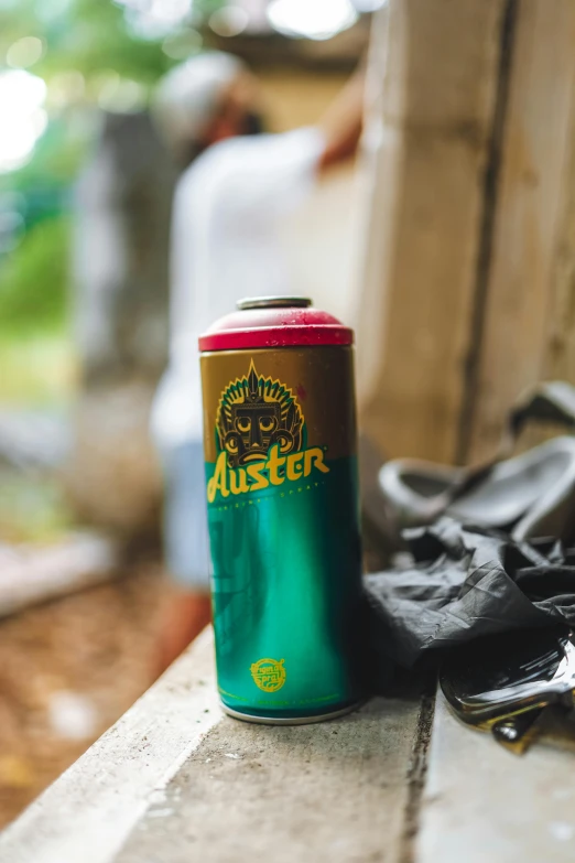 a can of beer sitting on top of a window sill, inspired by Jan Rustem, unsplash, graffiti, gold green creature, forest picnic, hysteria, teal color graded