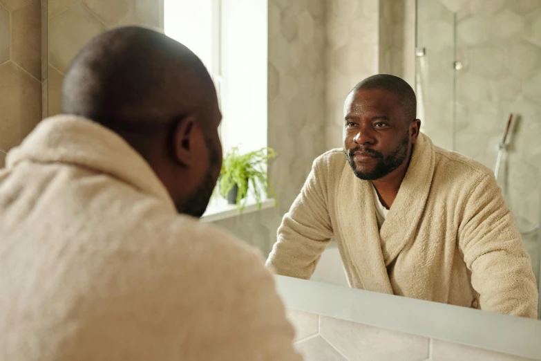 a man in a bathrobe looking at himself in the mirror, a portrait, shutterstock, mc ride, brown, grey, gilleard james