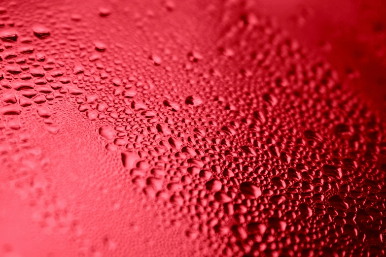a close up of water droplets on a red surface, by Thomas Häfner, metallic red, lightweight, thirst, decoration