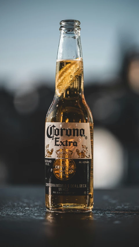 a bottle of coronano beer sitting on top of a table, by Carey Morris, pexels contest winner, single horn, corona, thumbnail, mexican