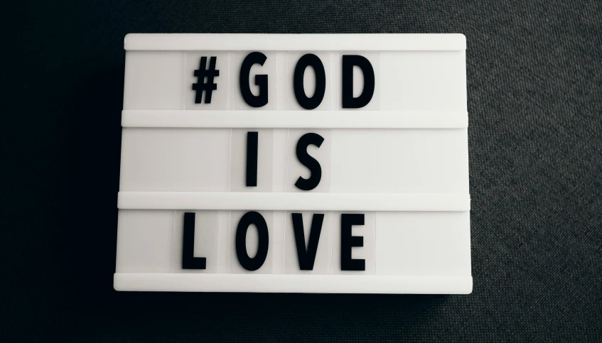 a sign that says god is love on it, a black and white photo, pexels, light box, patron saint of 🛸🌈👩🏾, avatar image, decoration