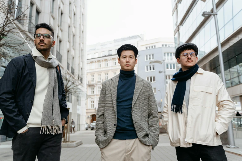 three men standing next to each other on a sidewalk, by Emma Andijewska, pexels contest winner, bauhaus, wearing a scarf, asian decent, avatar image, khakis