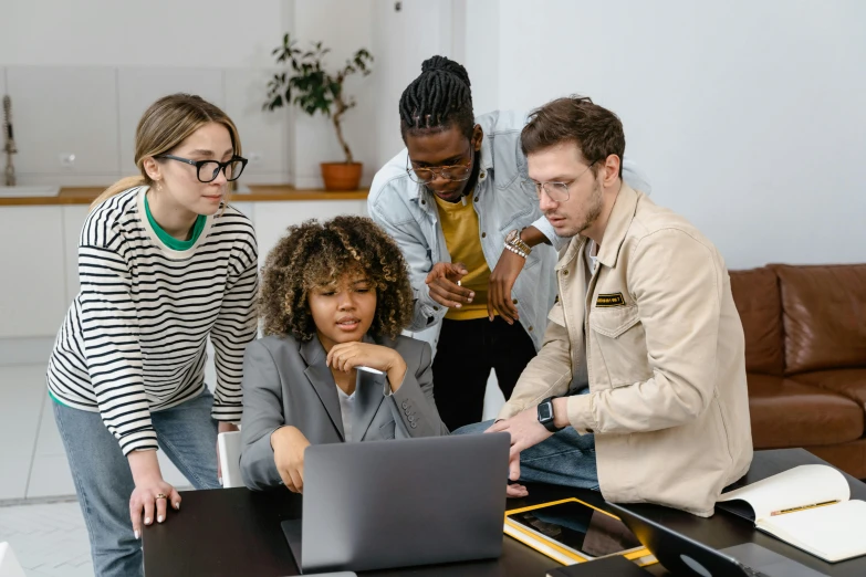 a group of people looking at a laptop computer, by Carey Morris, trending on pexels, standing on a desk, teaching, brown, gorecore