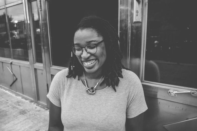 a black and white photo of a woman smiling, by Lily Delissa Joseph, nerdy black girl super hero, ☁🌪🌙👩🏾, brooklyn, laurie greasley and james jean