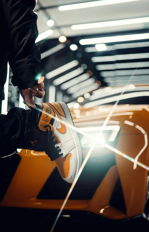 a man standing next to a yellow sports car, inspired by Mike Winkelmann, trending on pexels, hyperrealism, air jordan 1 high, orange and white, focus on his foot, lighting her with a rim light