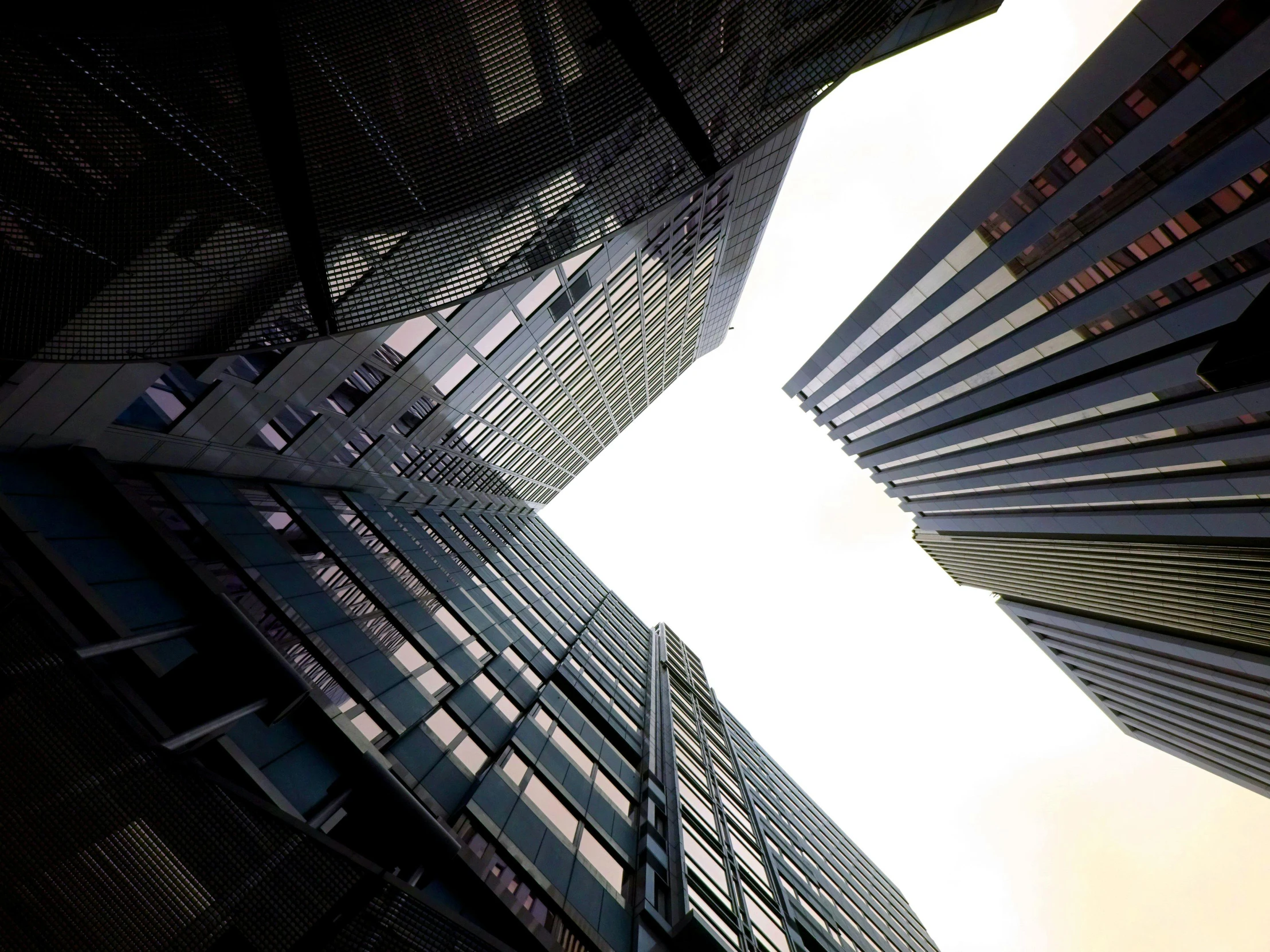 a group of tall buildings sitting next to each other, a screenshot, by Tobias Stimmer, pexels contest winner, view from the ground, bottom view ， bladerunner, shot on sony alpha dslr-a300, square lines