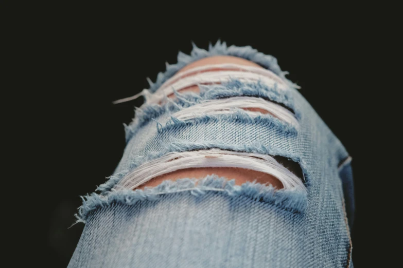 a close up of a person's ripped jeans, inspired by Elsa Bleda, trending on pexels, soft shade, ( ultra realistic, night time, a wooden