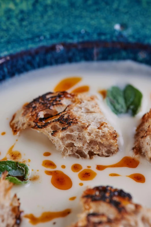 a close up of a plate of food on a table, inspired by Géza Dósa, bread, mint, good soup, thumbnail