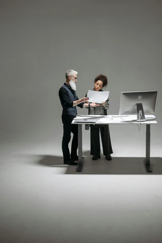 a man and woman standing in front of a laptop computer, a computer rendering, pexels, on a gray background, two skinny old people, office furniture, philippe starck