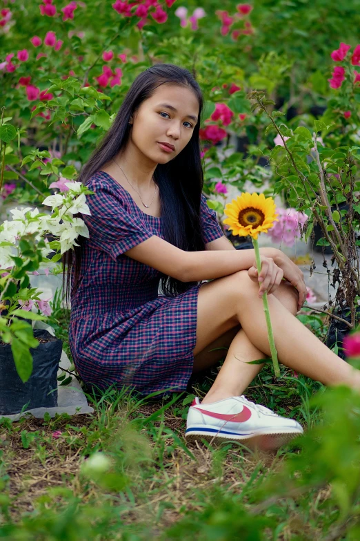 a woman sitting on the ground with a bunch of flowers, pexels contest winner, portrait of modern darna, garden, teenager, dang my linh