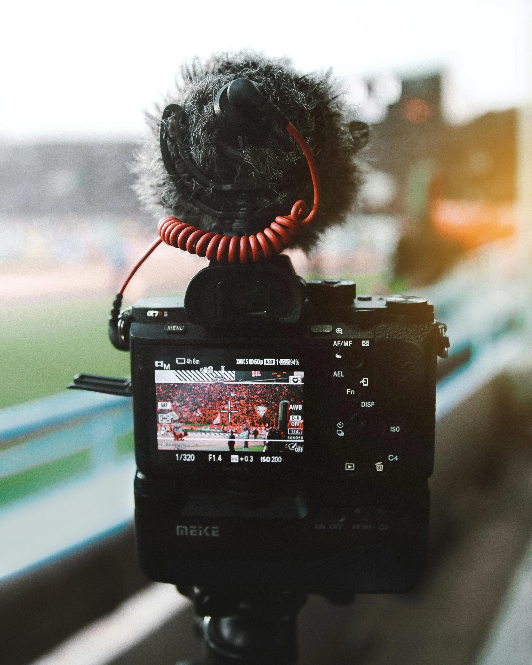 a camera with a microphone attached to it, pexels contest winner, video art, standing in a stadium, lgbtq, canon dslr, professional profile picture