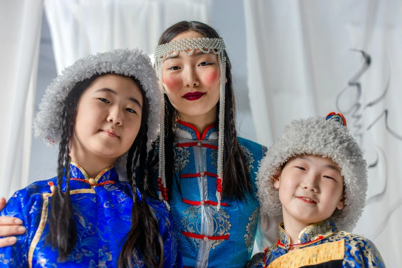 a couple of women standing next to each other, a portrait, trending on unsplash, cloisonnism, costume with blue accents, three women, young girls, (3 are winter