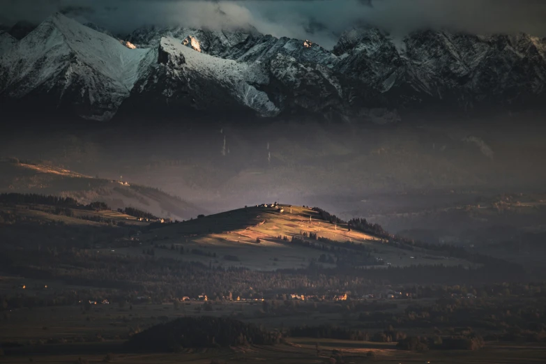 a mountain range with snow covered mountains in the distance, by Adam Marczyński, unsplash contest winner, renaissance, dramatic lighting 8k resolution, distant town in valley and hills, light and dark, lpoty