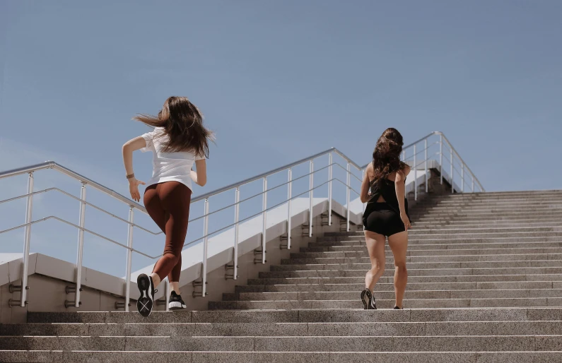 two women running up a flight of stairs, pexels contest winner, figuration libre, brunettes, wearing a tanktop and skirt, blank, working out