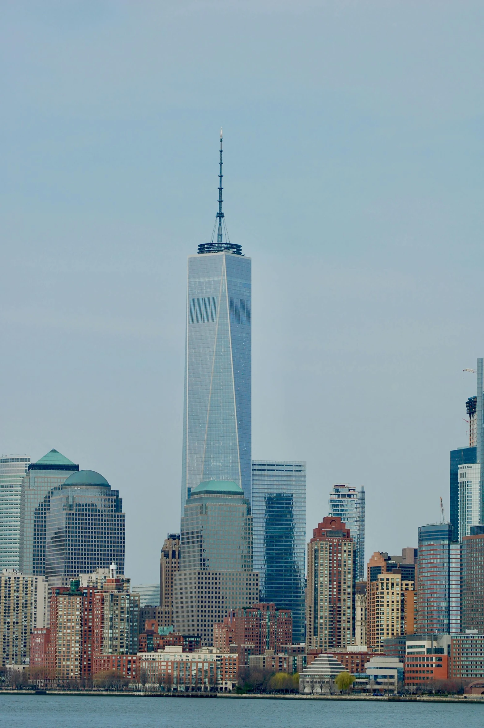 a large body of water with a city in the background, world trade center twin towers, slide show, travel, daytime