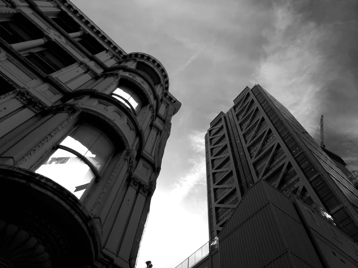 a couple of tall buildings next to each other, a black and white photo, by Adam Rex, post apocalyptic san francisco, neo - gothic architecture, japanese downtown, low angle photo