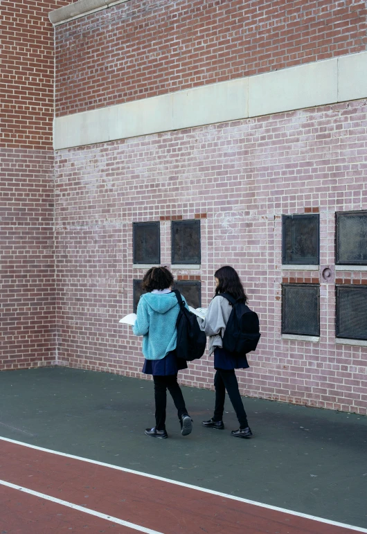 a couple of women standing on top of a tennis court, a photo, by Pamela Drew, heidelberg school, hiding behind a brick wall, in school hallway, 15081959 21121991 01012000 4k, walking away