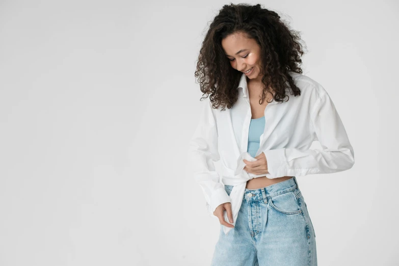 a woman in a white shirt and blue jeans, by Nina Hamnett, trending on pexels, renaissance, ashteroth, clothes floating, collared shirt, happy girl