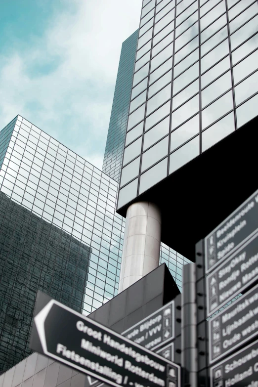 a bunch of signs on a pole in front of a building, by Jacob Toorenvliet, digital art, sleek glass buildings, ((monolith)), glass ceilings, tall minimalist skyscrapers