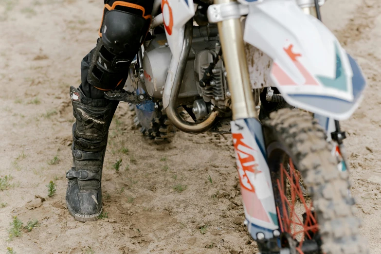 a close up of a person on a dirt bike, massive boots, profile image