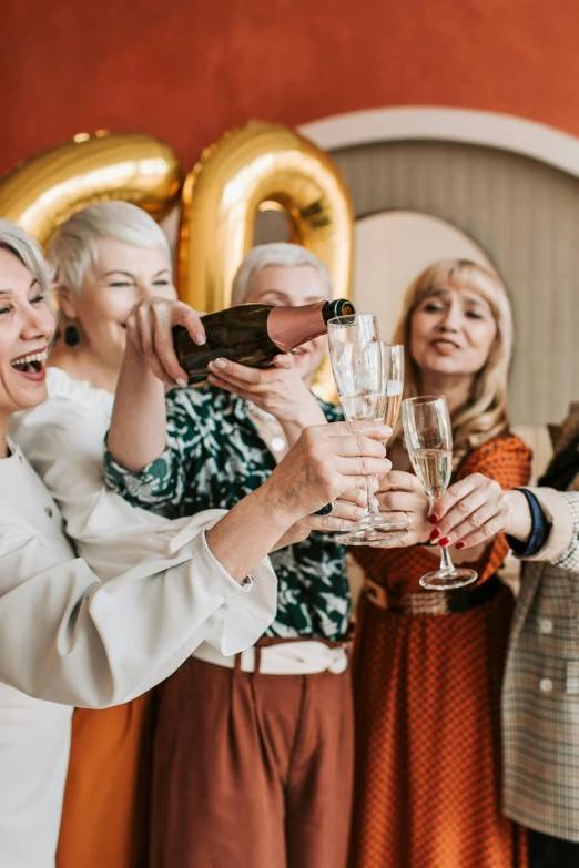 a group of women standing next to each other holding champagne glasses, pexels contest winner, happening, older woman, balloon, holding a gold bag, lots of wrinkles