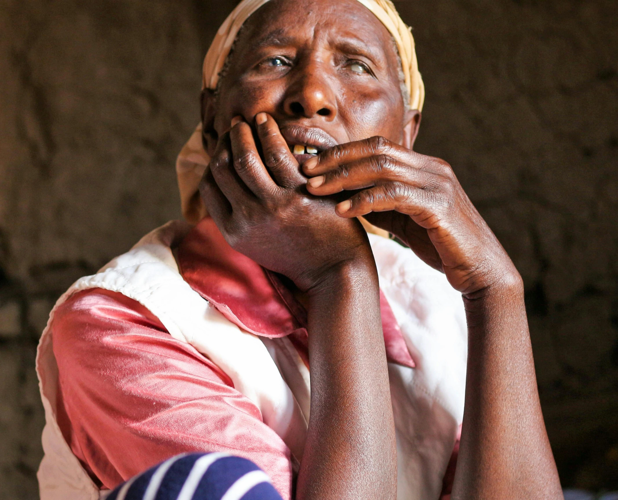 a woman that is sitting down with her hand on her chin, by Edwin Georgi, pexels contest winner, hurufiyya, malnourished, 2 5 6 x 2 5 6 pixels, slide show, unmistakably kenyan