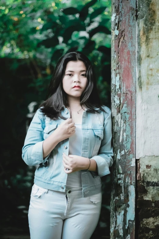 a woman standing in the doorway of an old building, inspired by Bernardino Mei, pexels contest winner, realism, jean jacket, 🤤 girl portrait, bbwchan, young asian girl