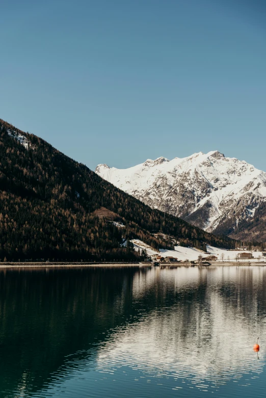 a body of water with mountains in the background, by Tobias Stimmer, pexels contest winner, winter lake setting, 4 k cinematic panoramic view, alp, slightly minimal