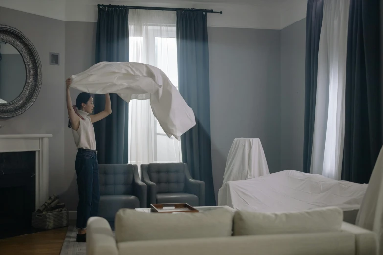 a woman holding a sheet over her head in a living room, pexels contest winner, hyperrealism, big long cloth on the wind, uhd cinematic lighting, behind the scenes photo, furniture