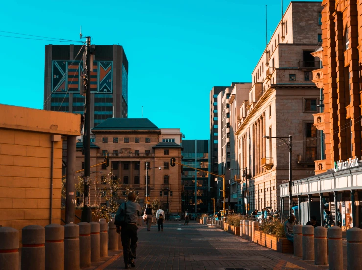 a man riding a bike down a street next to tall buildings, by Lee Loughridge, pexels contest winner, coloured in teal and orange, on a great neoclassical square, late morning, preserved historical