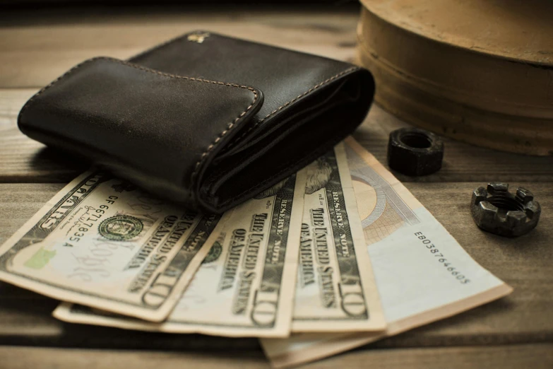 a wallet sitting on top of a pile of money, a portrait, pexels contest winner, renaissance, nice afternoon lighting, thumbnail, 10k, brown