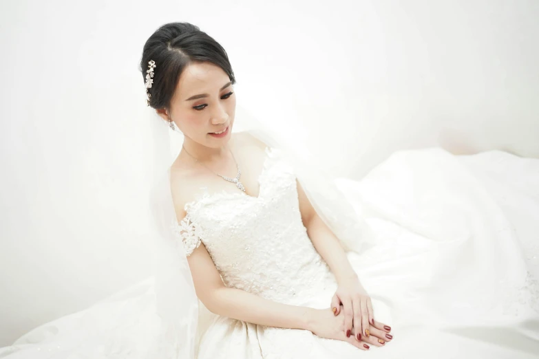 a woman in a wedding dress sitting on a bed, inspired by Wen Jia, pexels contest winner, white backdrop, marble white complexion, closeup - view, tiffany style