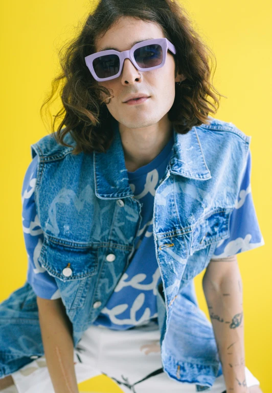 a woman wearing sunglasses and a denim jacket, an album cover, by Winona Nelson, caleb worcester, patterned clothing, official store photo, sigourney weaver