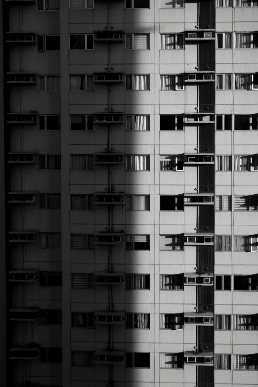 a black and white photo of a tall building, a black and white photo, by Tobias Stimmer, unsplash, brutalism, hong kong, house windows, diptych, :: morning