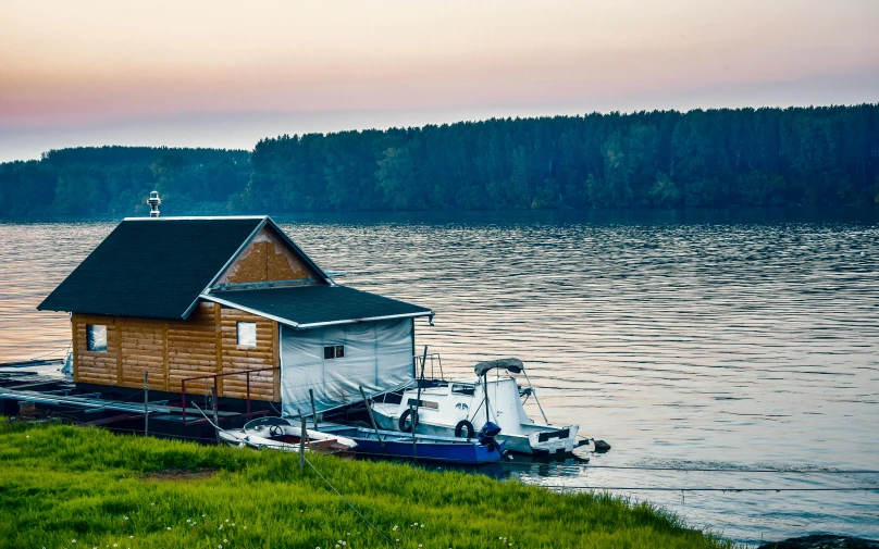 a small house sitting on top of a body of water, moored, rutkoswki, professional photo, fan favorite