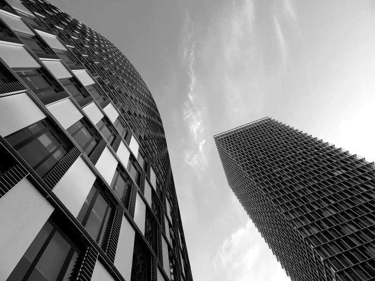 a couple of tall buildings next to each other, a black and white photo, by Adam Rex, unsplash contest winner, minimalism, full of glass. cgsociety, sunny day, foster and partners, realistic architecture