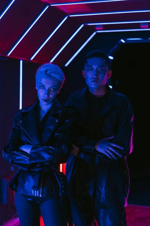 two people standing next to each other in a dark room, wearing futuristic clothing, commercially ready, high school, promotional image