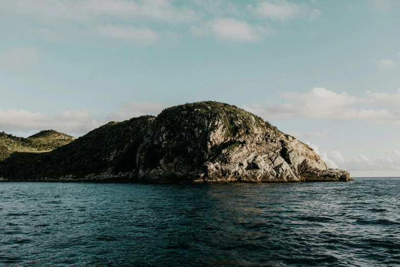 a large rock in the middle of a body of water, unsplash, te pae, archipelago, profile image, view from the sea