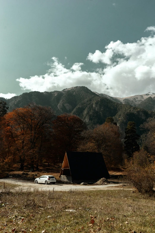 a car is parked in front of a small cabin, unsplash contest winner, minimalism, autumn mountains, today\'s featured photograph 4k, mount olympus, multiple stories