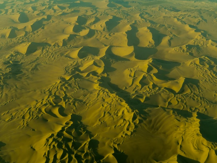 a view of the desert from an airplane, pexels contest winner, land art, yellow and green, moonscape, mesopotamic, landslides