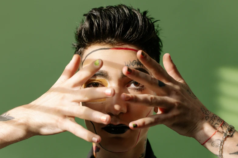 a close up of a person making a face with their hands, an album cover, inspired by Hedi Xandt, trending on pexels, asian man, androgynous person, green colored skin, color ( sony a 7 r iv